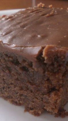 a piece of chocolate cake sitting on top of a white plate