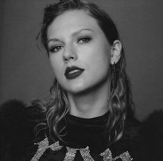 a black and white photo of a woman with dark lipstick