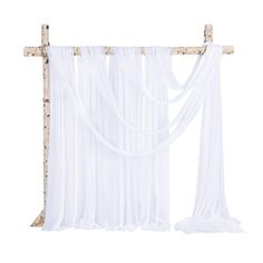 a white curtain hanging from the side of a wooden frame