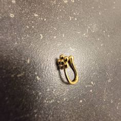 a small gold ring sitting on top of a table