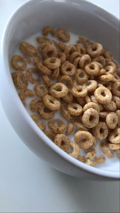 a bowl filled with cereal sitting on top of a table