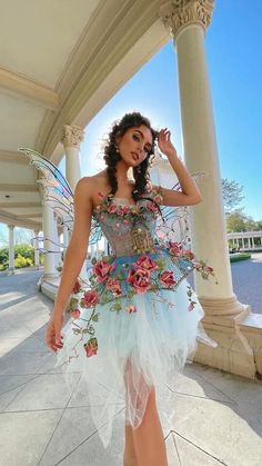 a woman in a fairy costume posing for the camera