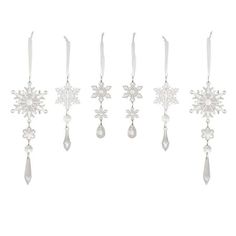 six snowflakes hanging from the side of each other with white ribbons on them