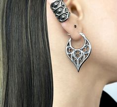 Unique pointy hoops are inspired by Gothic Cathedral elements.  Hoop are made of 316 Stainless steel. Size of the hoop : 37mm long,25mm wide Standard Post 22G Sold as 1 Pair Ships in a gift box *RETURNS / REFUNDS * -If you would like to return you purchase , please contact us within 7 days of receiving your package and we will accept the return.Return will only be made to the product, and not the shipping cost.  -Buyer is  responsible for the return shipping costs . -All jewelry must be returned unworn and in their original condition . *LOST MAIL* Once the package is marked as DELIVERED by the post office, we are not responsible for misplaced or stolen packages. *MAIL THEFT* If parcel is stoled or vandalized, please contact USPS mail theft department for further directions. We are not resp Silver Gothic Plug Earrings For Festival, Fantasy Festival Earrings, Gothic Metal Hoop Earrings, Gothic Hoop Earrings For Pierced Ears, Gothic Hoop Cartilage Earrings, Festival Edgy Earrings For Pierced Ears, Gothic Silver Hoop Earrings For Pierced Ears, Gothic Nickel-free Cartilage Earrings, Nickel-free Gothic Plug Earrings For Festivals