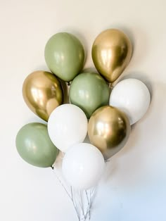 a bunch of balloons that are in the shape of a heart on a white wall