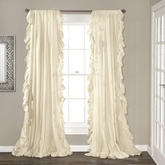 a white curtain with ruffled edges in front of a window