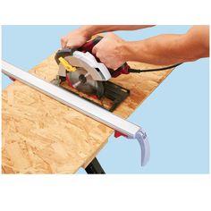 a man using a circular saw to cut plywood planks with a power tool