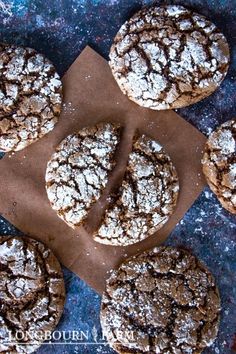 several chocolate crinkle cookies on a piece of parchment paper