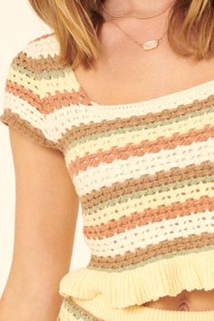 a close up of a woman wearing a top with crochet on the bottom