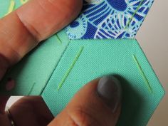 someone is stitching the side of a piece of fabric