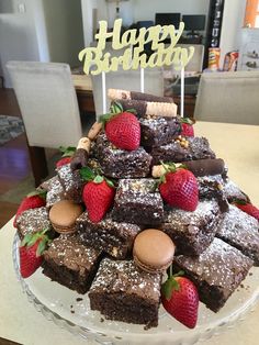 a birthday cake with strawberries and chocolate brownies