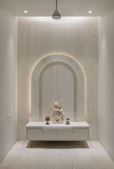 a white room with marble walls and an arch in the center, surrounded by gold accents