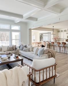 a living room filled with furniture and lots of windows