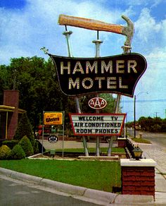 an old fashioned sign for a motel in the country