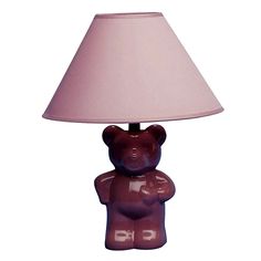 a purple teddy bear lamp sitting on top of a table next to a pink shade