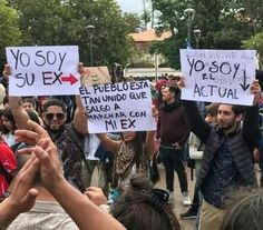 several people holding up signs in the air