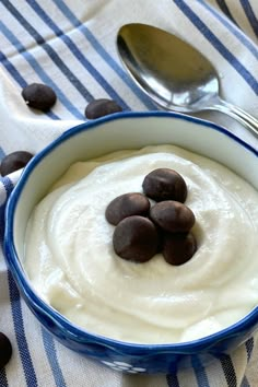 a bowl filled with pudding and chocolate chips on top of a blue striped table cloth