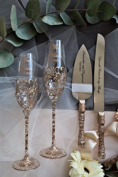 two wine glasses and a knife on a table