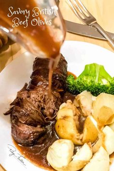 someone is pouring sauce on some meat and potatoes with broccoli in the foreground