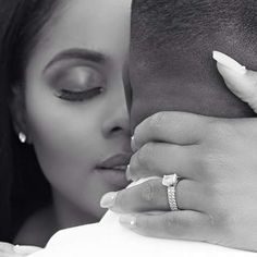 a close up of a person kissing a woman with a ring on her finger and the man's face behind them