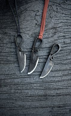 two knives are attached to a cord on a table