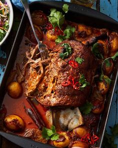 a roasting pan filled with meat and vegetables