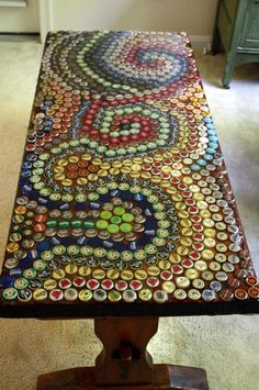 a table made out of bottle caps on top of a carpeted floor in front of a door