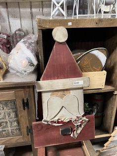 a wooden birdhouse sitting on top of a shelf next to other woodworking items