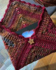 a close up of a knitted scarf on a table