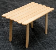 a small wooden table sitting on top of a carpet