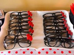 two trays with glasses and red flowers on them