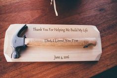 a hammer on top of a wooden block with the words thank you for helping me build my life