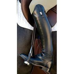 a close up of a horse's boots and saddle