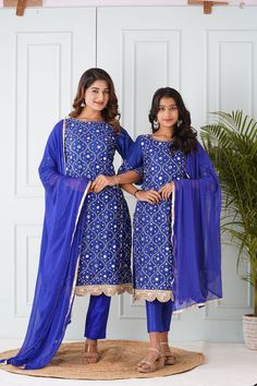 Mother's Salwar Kameez:-Cotton Silk Pakistani Suit in Royal Blue This Readymade Hand Embroidered attire with Cotton Lining is Enhanced with Pocket, Tassels, All Over Mirror, Zari, Cutbeads work along With Fancy Mirror Scalloped Border. Crafted in Round Neck and Quarter Sleeve. Available with an Art Silk Pant with Cotton Lining in Royal Blue and a Gota Lace Work Faux Chiffon Dupatta in Royal Blue. The Kameez and Bottom Lengths are 43 and 36 inches respectively Do note: Accessories shown in the im Traditional Blue Sharara With Straight Kurta, Festive Blue Palazzo Set With Zari Work, Blue Unstitched Sharara For Festive Occasions, Festive Blue Sharara With Straight Kurta, Blue Sharara With Straight Kurta For Festive Occasions, Blue Embroidered Bollywood Palazzo Set, Blue Bollywood Embroidered Palazzo Set, Festive Blue Unstitched Sharara, Bollywood Style Blue Embroidered Palazzo Set