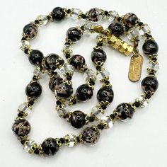 Vintage Murano glass Venetian SRM Italy black and gold beaded necklace Approximately 17" long Clear, black and gold glitter bead with ornate gold bead caps and clear spacer beads Barrel closure Signed SRM Italy Great vintage condition Gold Beaded Necklace, Gold Bead Necklace, Bead Caps, Murano Glass, Gold Beads, Spacer Beads, Black And Gold, Gold Glitter, Beaded Necklace