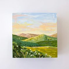 an acrylic painting of green hills and flowers