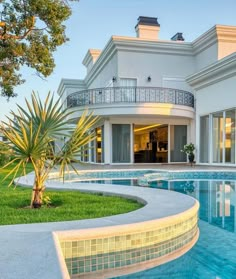 a large house with a swimming pool in front of it