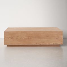 a wooden box sitting on top of a white floor