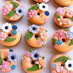 there are many decorated doughnuts on the table