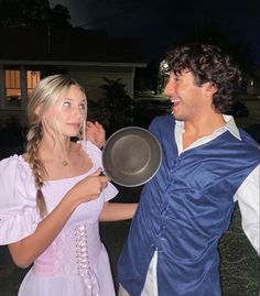 a man and woman dressed up as peter panton and aurora from beauty and the beast