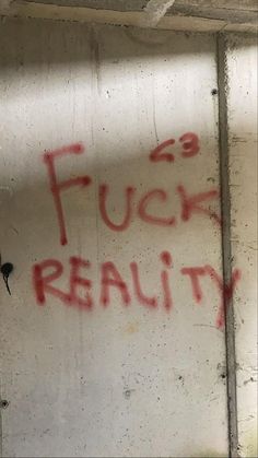 graffiti on the side of a building that says, fuch reality