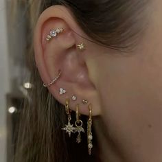 a close up of a person's ear with three different types of piercings