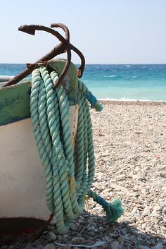 a boat on the beach with a quote about life's roughest storms prove the strength of our anchors