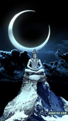 a buddha statue sitting on top of a mountain under a crescent moon