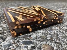 two pieces of chocolate sitting on top of a stone floor next to rocks and gravel