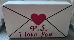 an open white box with a red heart on it and the words p s i love you