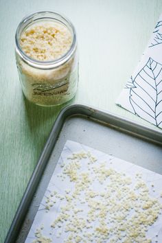 a cookie sheet is next to a jar of sugar