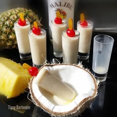 there are many different types of drinks on the table with pineapples and bananas