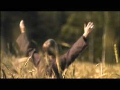 a blurry photo of two people in the grass with their hands up and arms outstretched