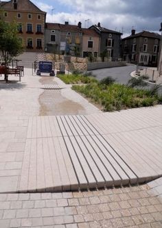 an empty walkway in front of some buildings